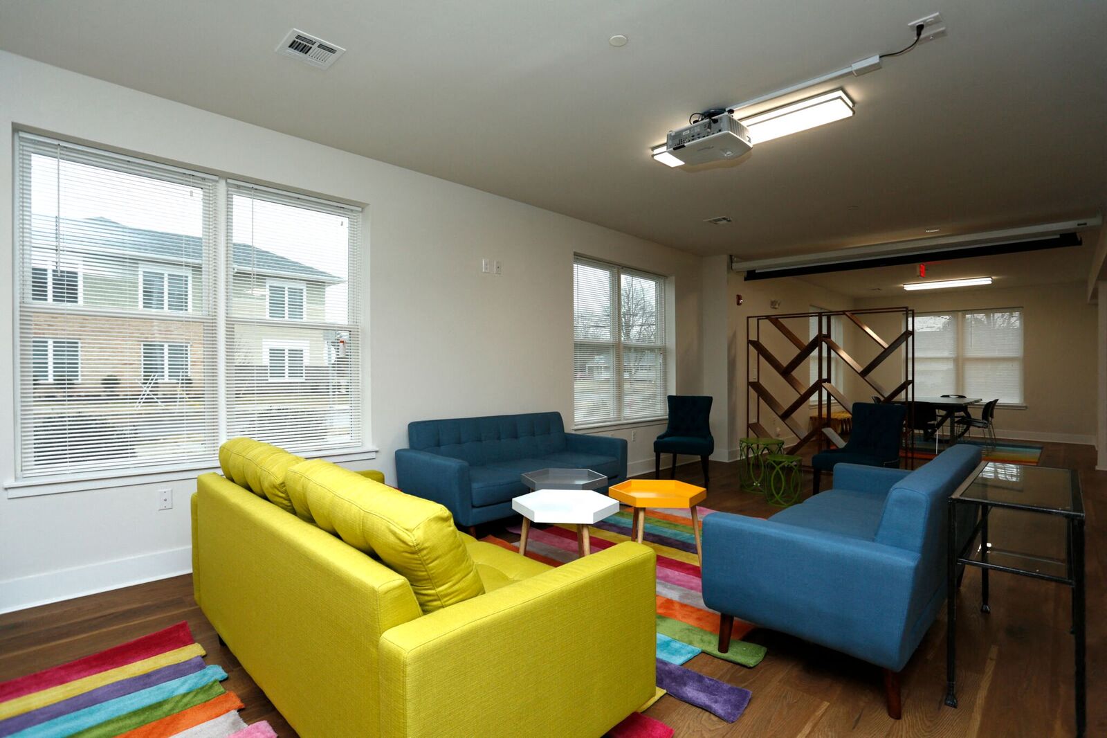 community room with seating area surrounding coffee tables