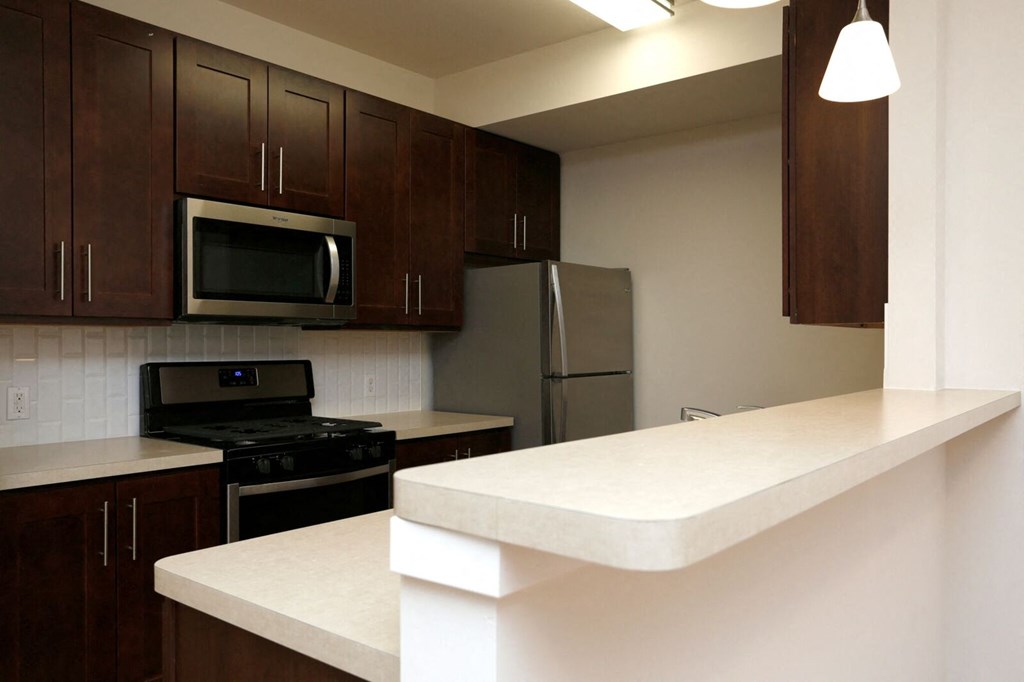 a kitchen with a counter top and a refrigerator