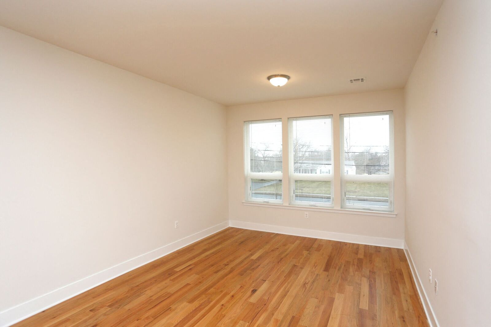 living room with hardwood floors and white walls