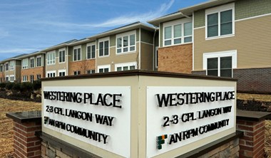 Exterior of building with sign that read "Westering Place: An RPM Community"