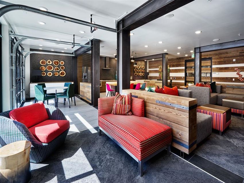 a lobby with couches and chairs and a table