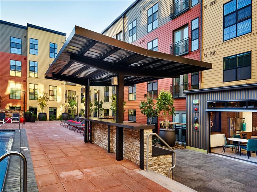 a patio with a bar in a courtyard