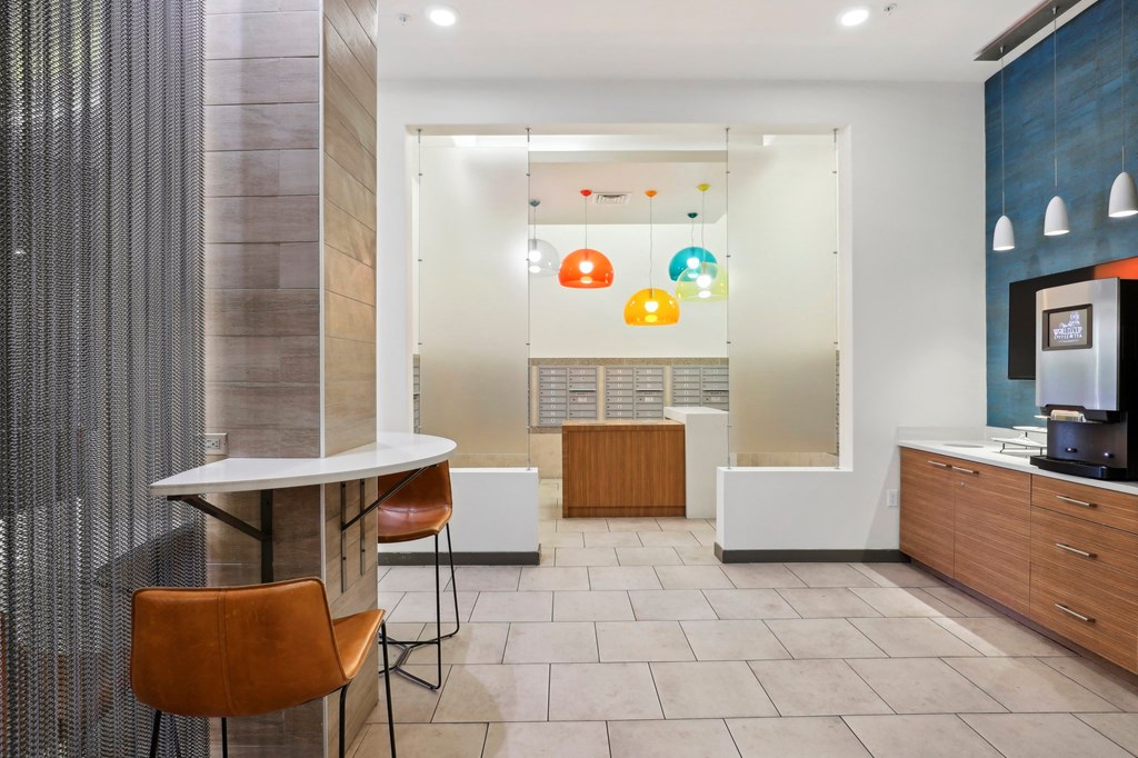 a reception area with two stools and a television in a hotel lobby