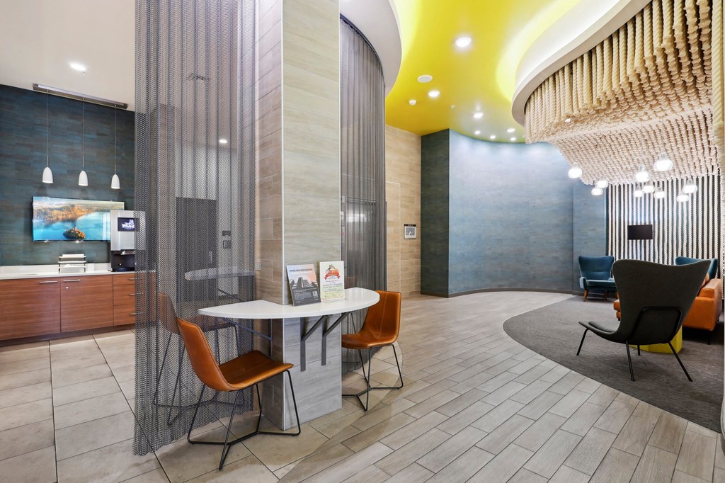 a lobby with a table and chairs and a chandelier