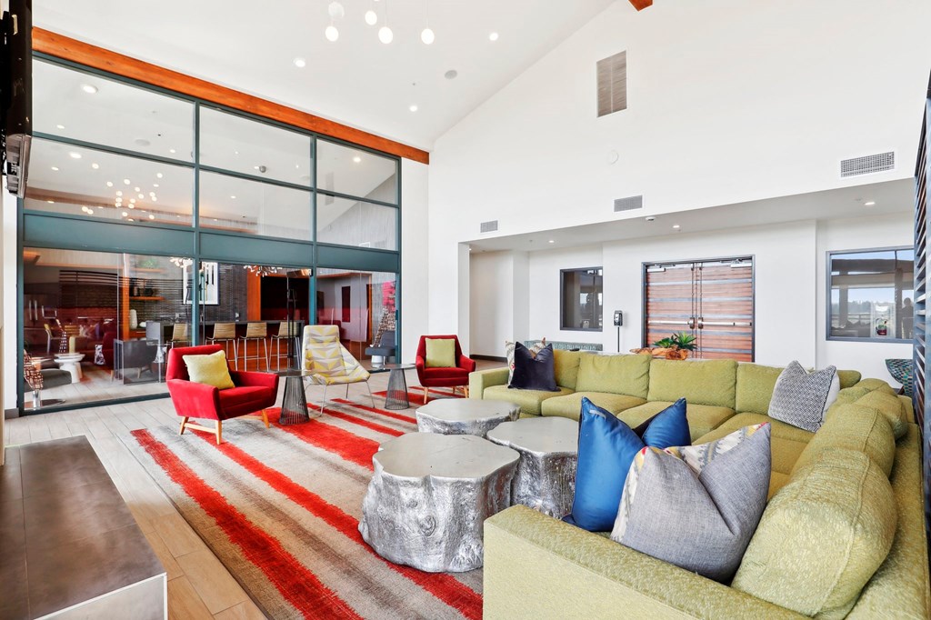 a living room with couches and chairs and a rug