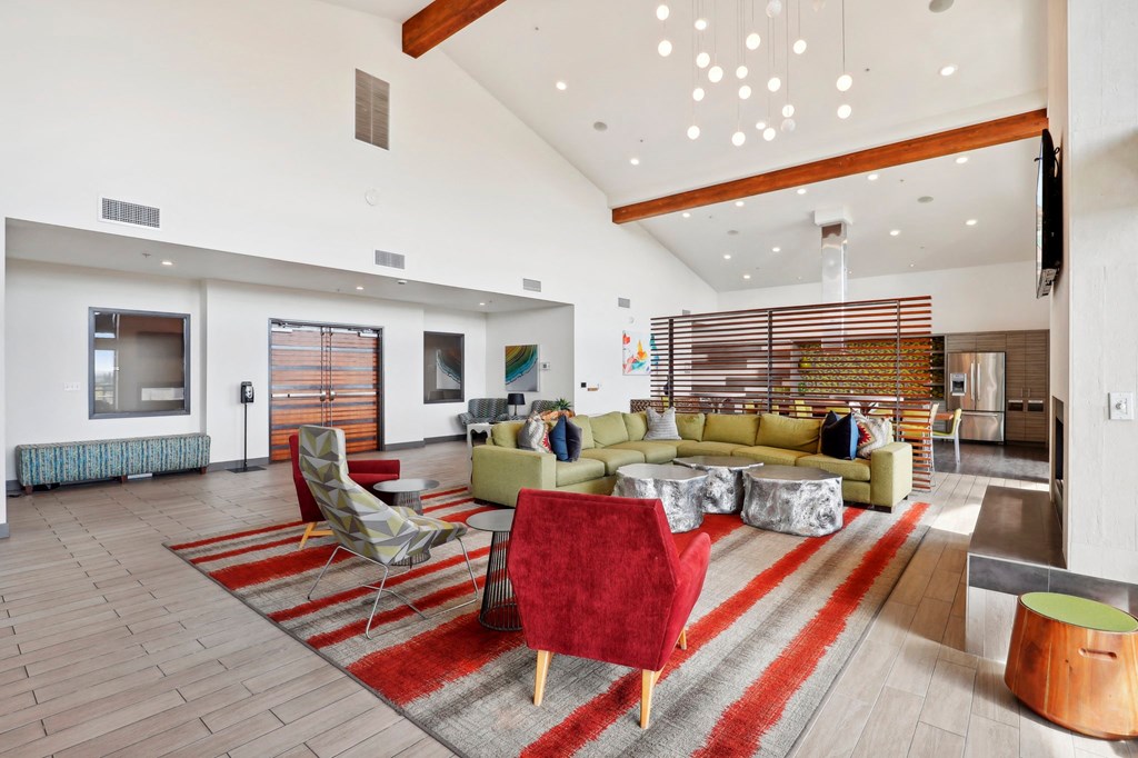 a living room with couches and chairs and a rug