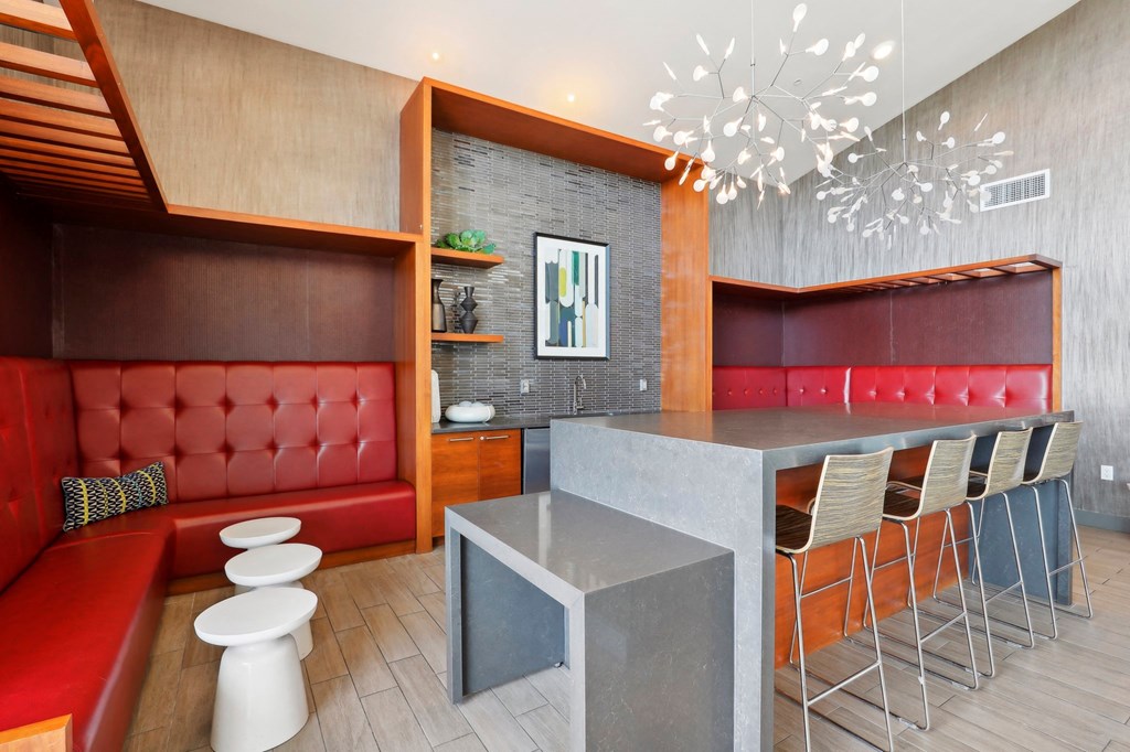 a restaurant with red booths and a counter with stools