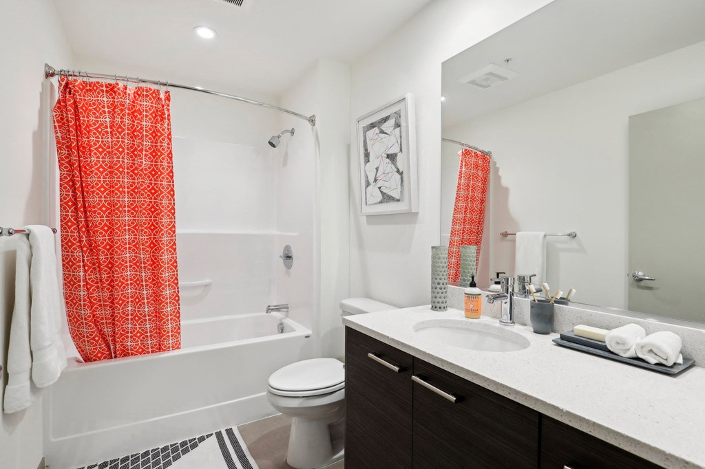 a bathroom with a sink toilet and shower and a tub