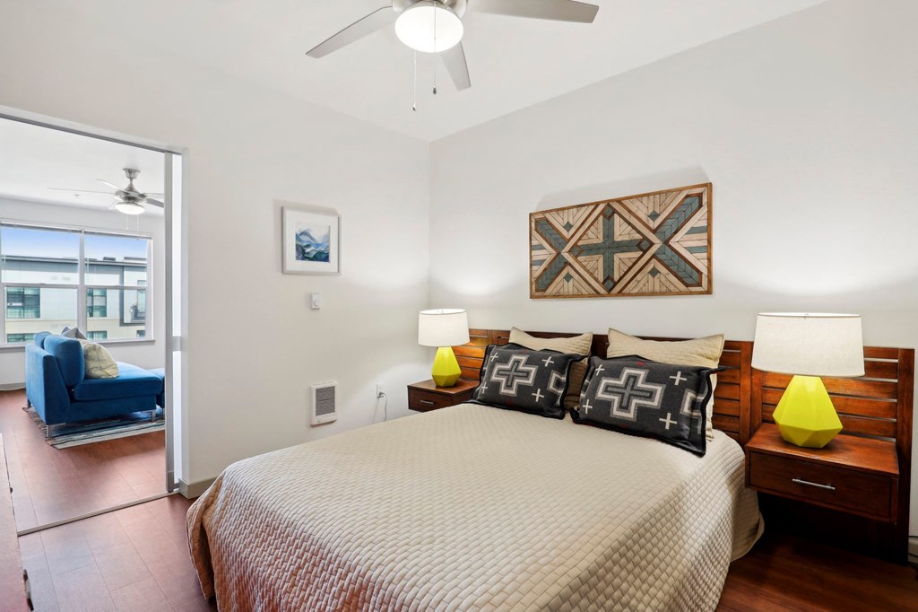 a bedroom with a large bed and a ceiling fan