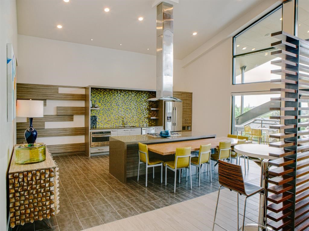 a kitchen and dining room with yellow chairs