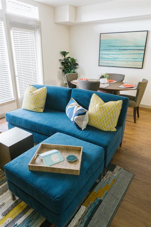 a living room with a blue couch and a table