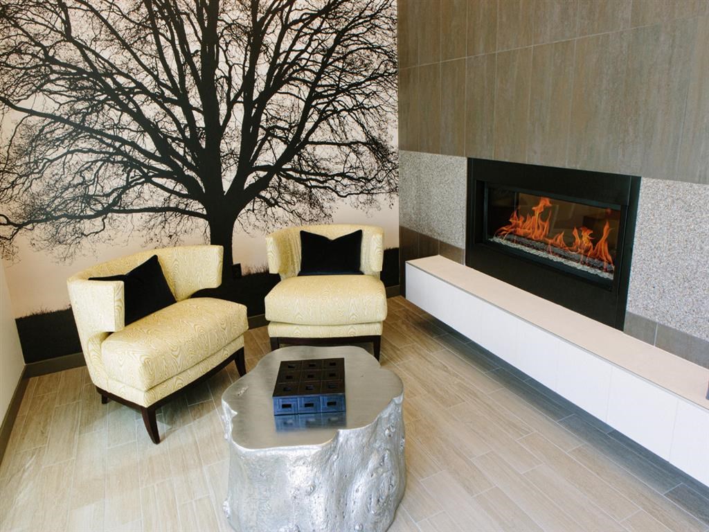 a living room with two chairs and a fireplace
