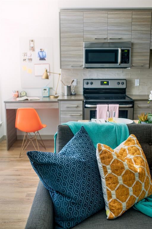 a living room with a couch and a microwave