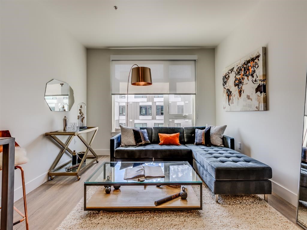 a living room with a couch and a glass coffee table