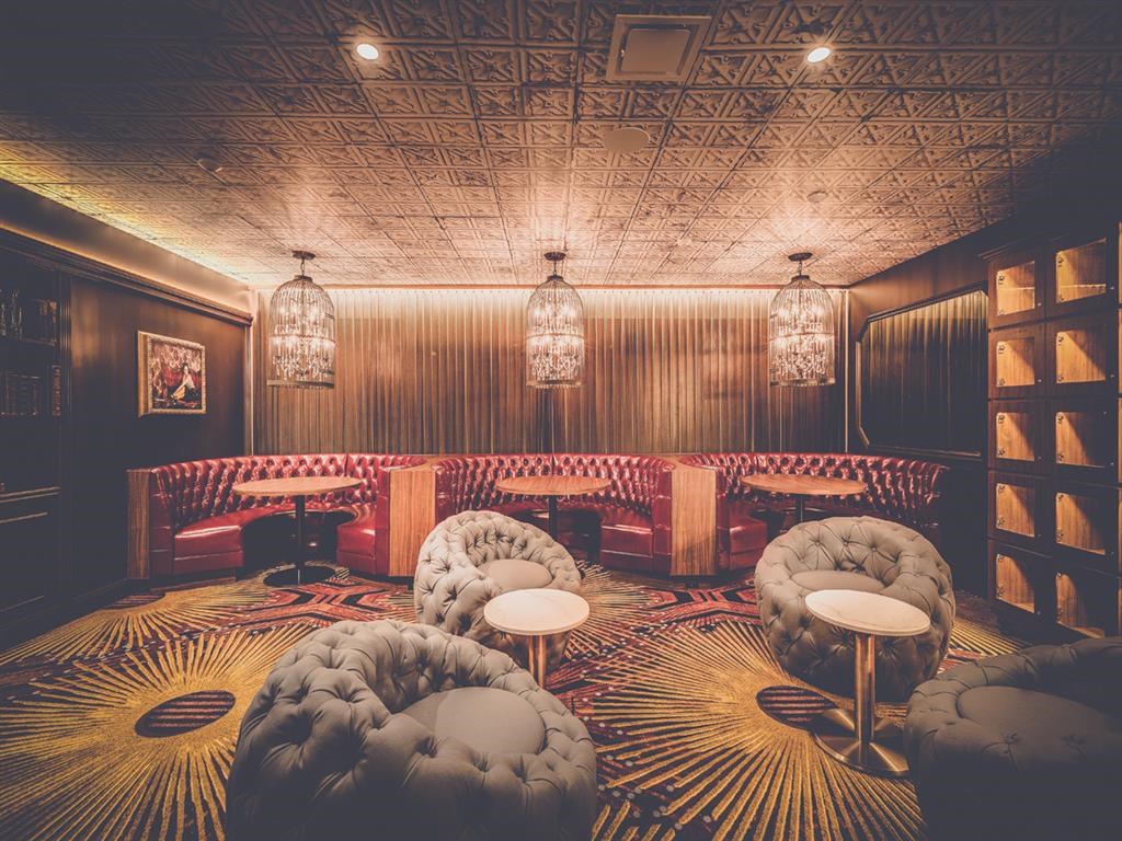 the lounge or bar of a restaurant with couches and chairs