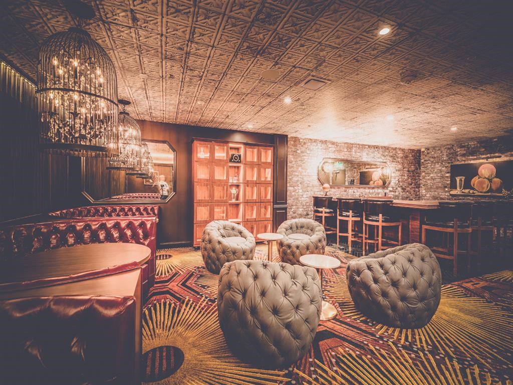 a room with chairs and a table and a bar