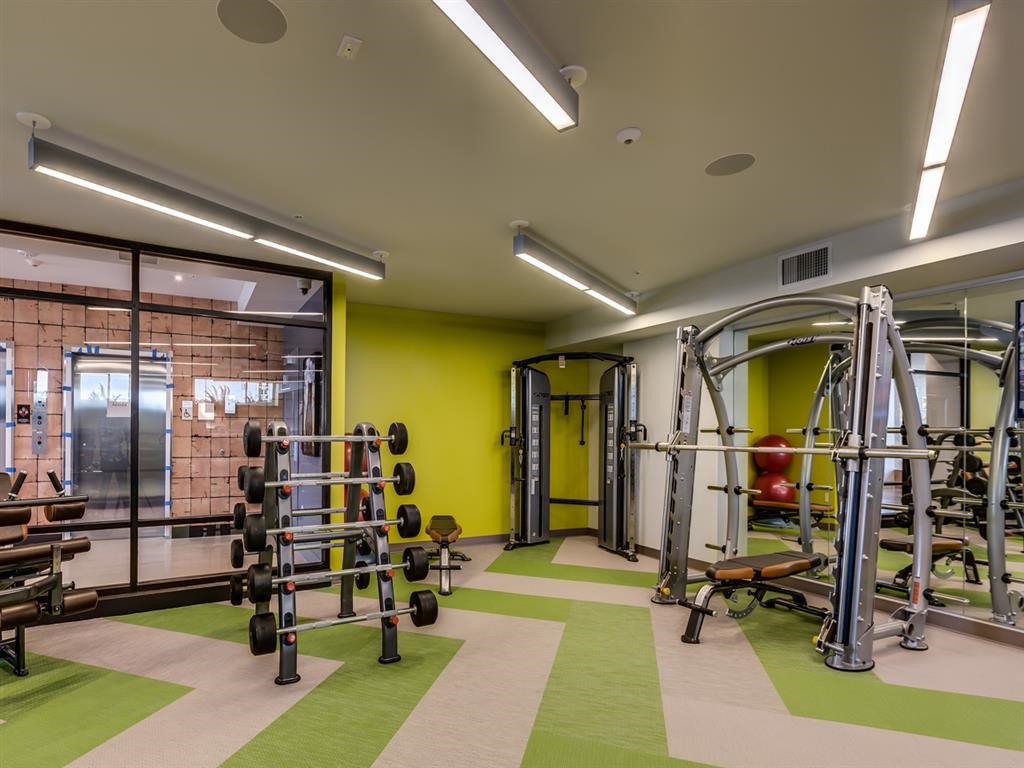 a gym with weights and other equipment in a building