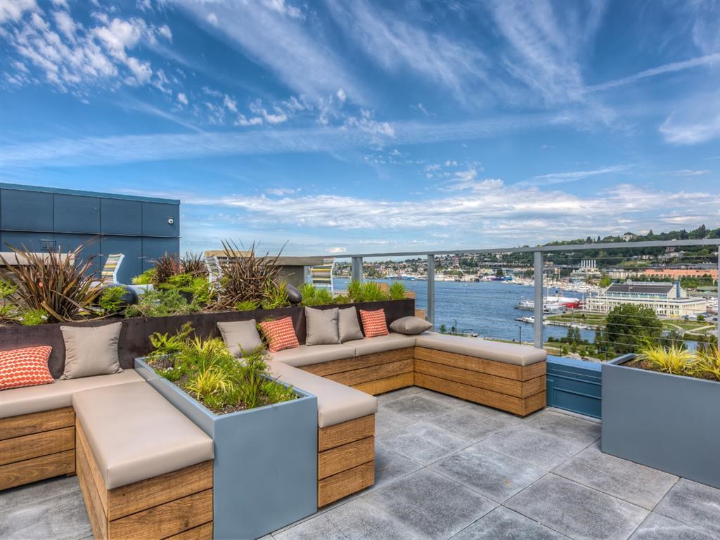 a roof terrace with a view of the city and the ocean