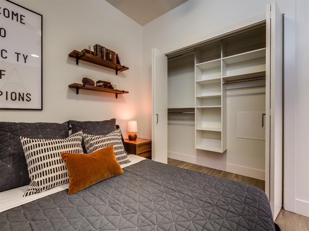 a bedroom with a bed and a closet