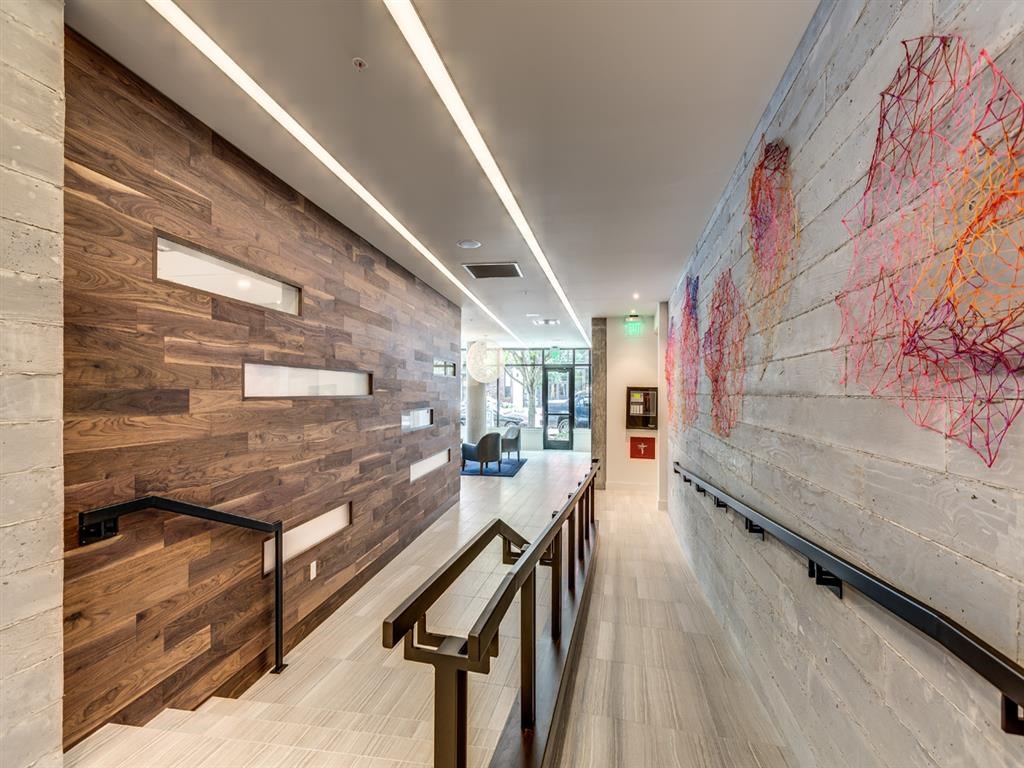 a hallway with a painting on the wall and a staircase