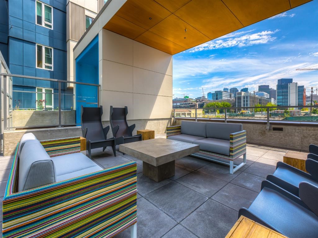 a patio with furniture and a view of the city