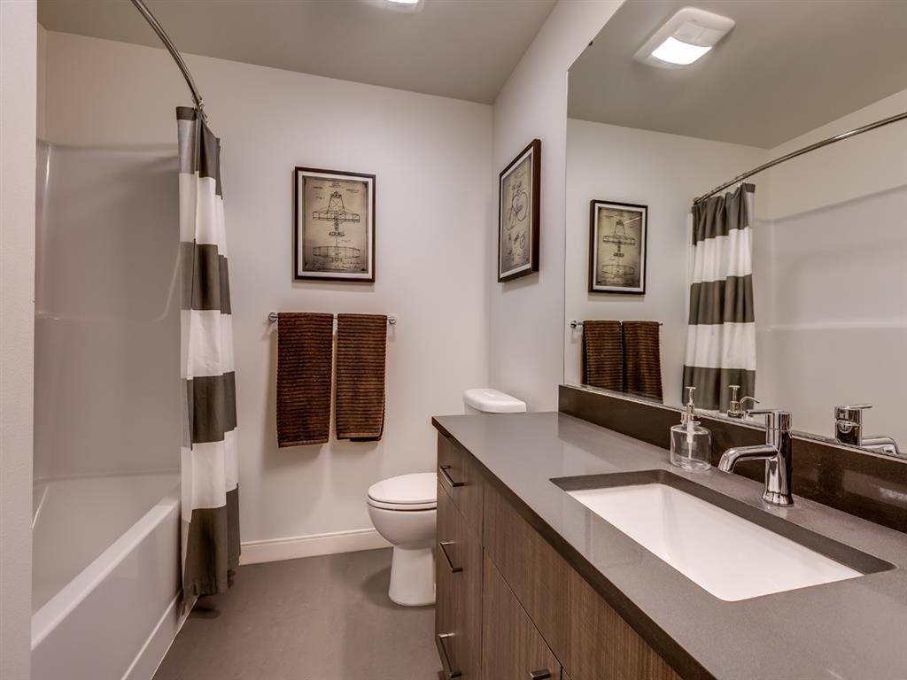a bathroom with a sink and a toilet and a shower