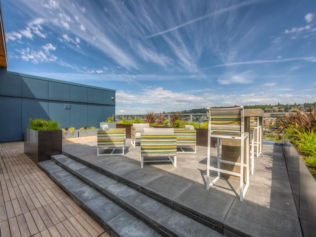 a terrace with tables and chairs on a roof