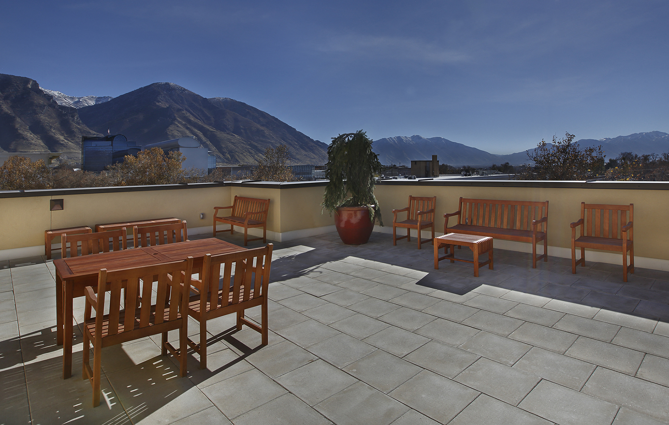 Liberty Center Apartments, Provo, Utah, rooftop balcony with wood table and benches, overlooking the mountains