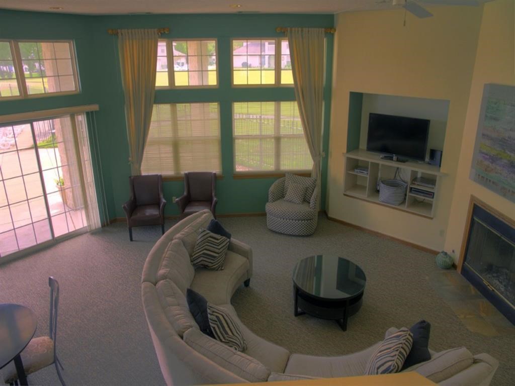 a living room with a couch and chairs and a television