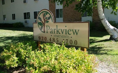 a parkview apartments sign in front of a building