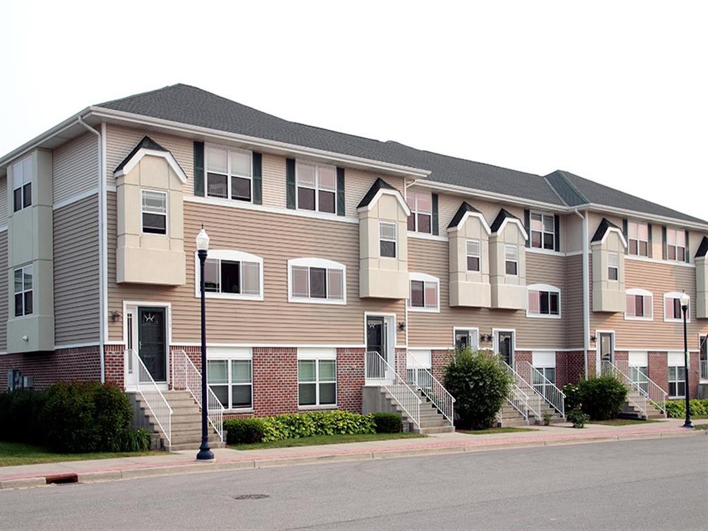 an apartment building on the corner of a street