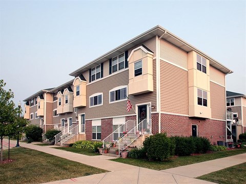 a building with stairs and a flag in front of it