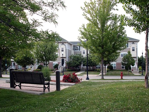a park bench sitting in front of a building