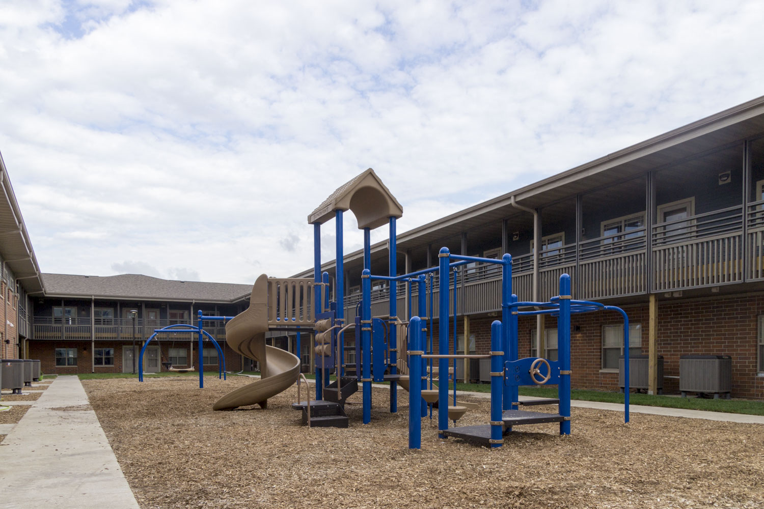 a playground at a school with a blue playset