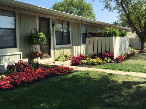 a house with a flower garden in front of it