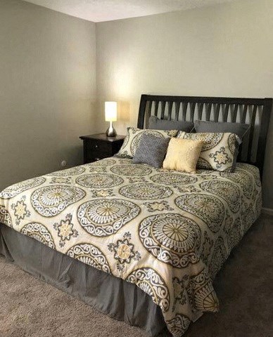 a bedroom with a bed and a lamp