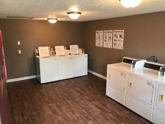 a laundry room with two washes and a dryer