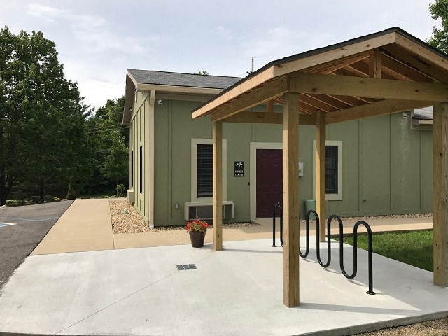a small building with a porch and a bike rack