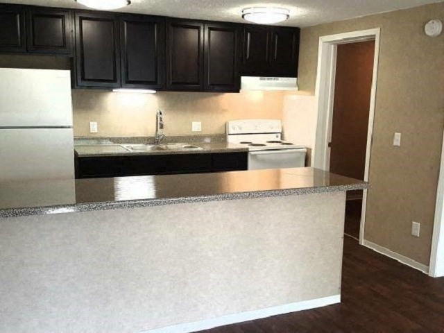 a kitchen with black cabinets and a counter top