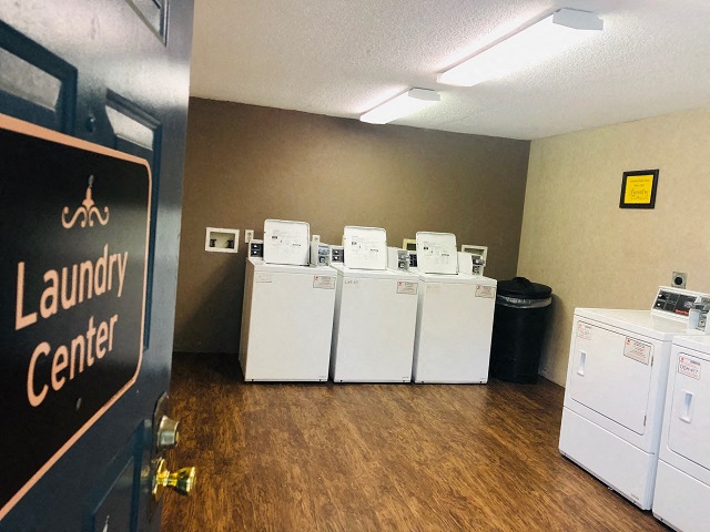 a laundry room with a row of washing machines