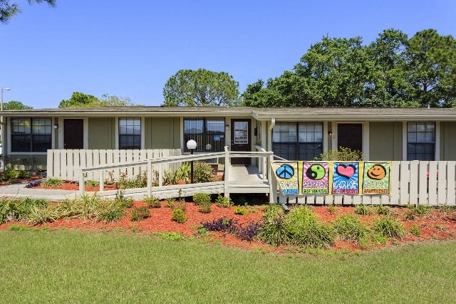 a house with a porch and a garden in front of it