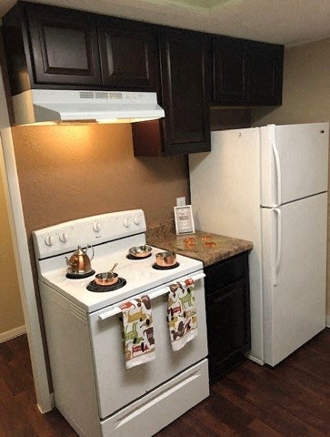 a small kitchen with a stove and a refrigerator