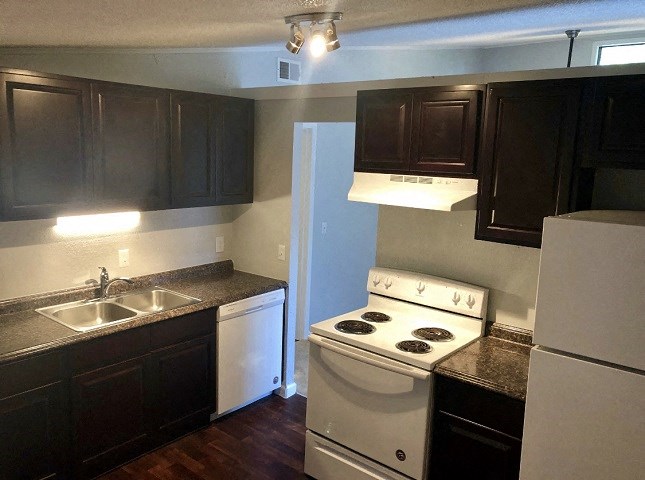 a kitchen with a stove and a sink