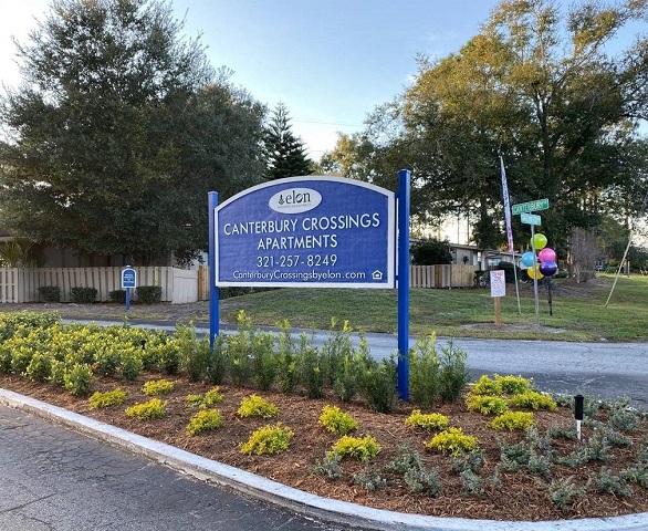 a sign for gateway crossings apartments in front of a street
