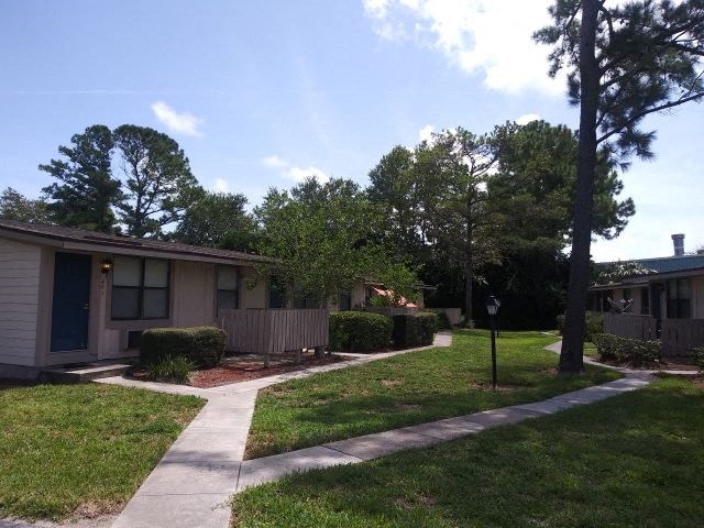 a sidewalk in front of a small house