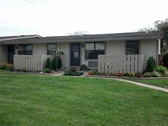 a house with a yard and a white fence