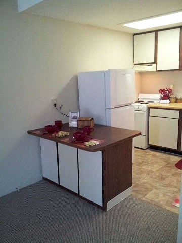 a small kitchen with a counter and a refrigerator