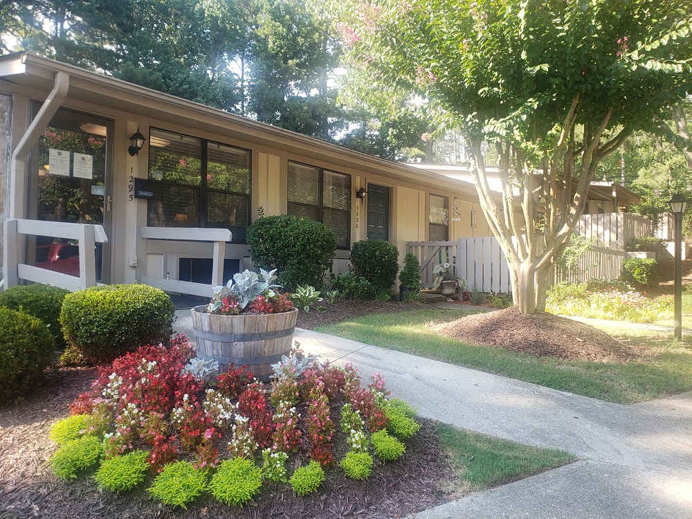 a front yard with a fountain in front of a house