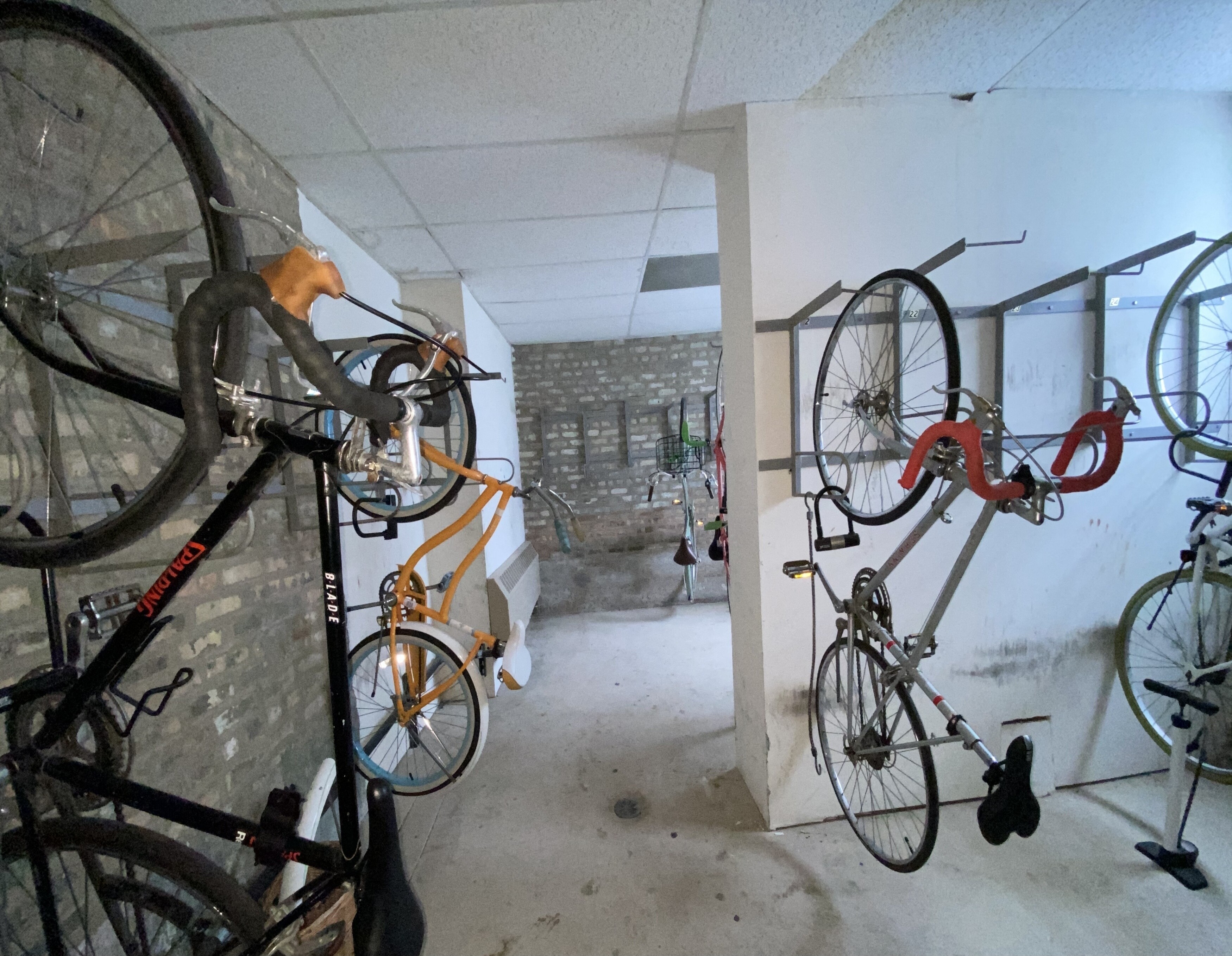 a room filled with bikes hanging on a wall