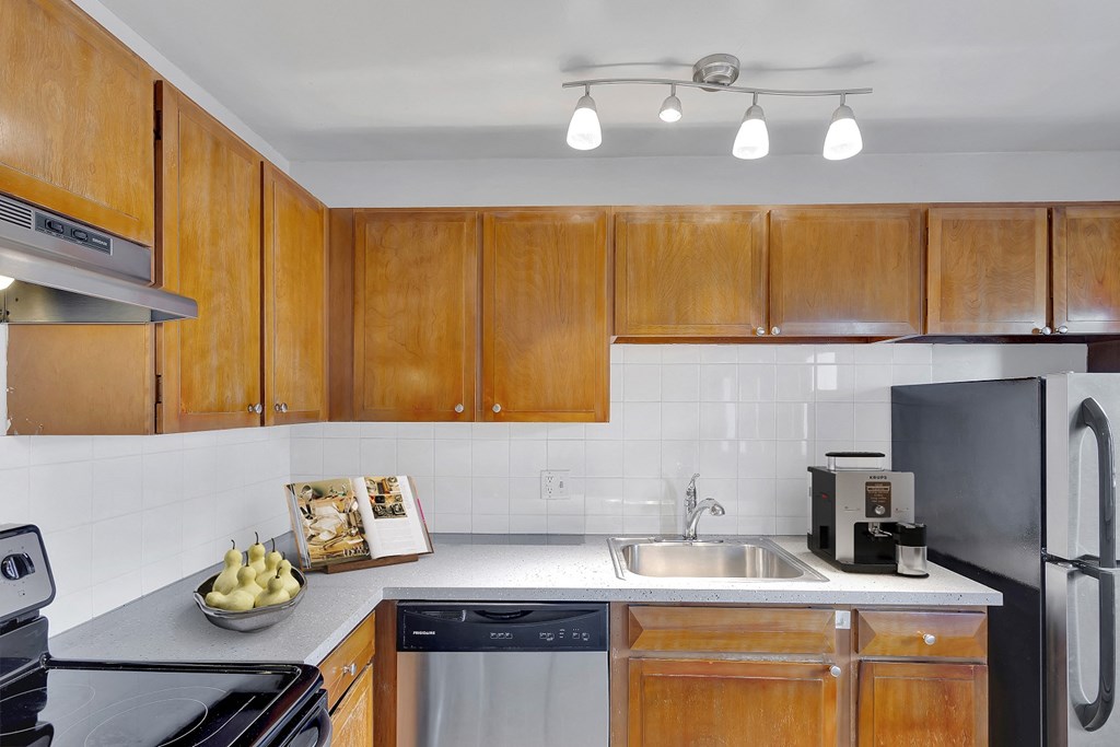 a kitchen with wooden cabinets and a sink